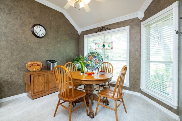 dining room with ceiling fan, lofted ceiling, crown molding, and light tile patterned floors