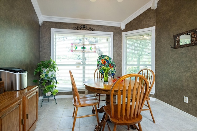 dining room featuring crown molding, light tile patterned floors, and lofted ceiling