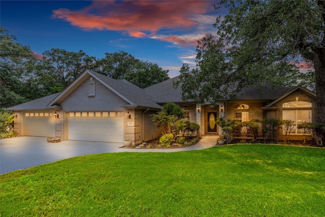 view of front of home featuring a lawn and a garage