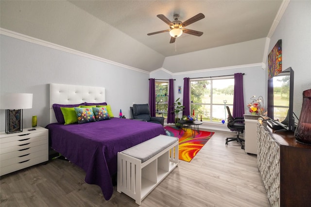 bedroom featuring ceiling fan, crown molding, vaulted ceiling, and light wood-type flooring