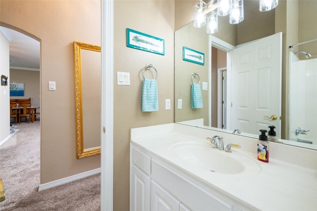 bathroom with crown molding and vanity