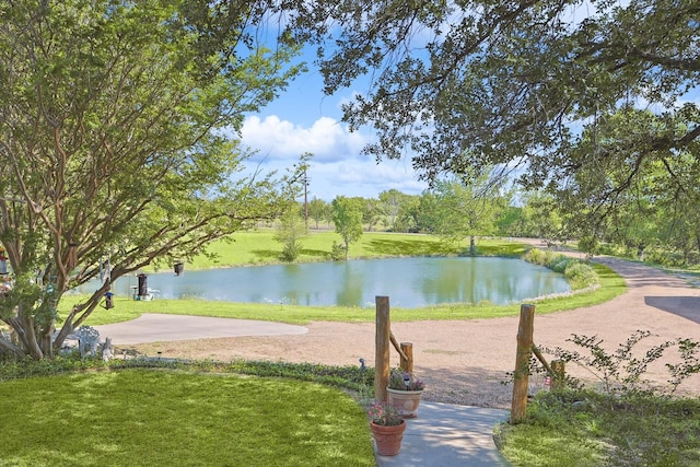 surrounding community with a yard and a water view