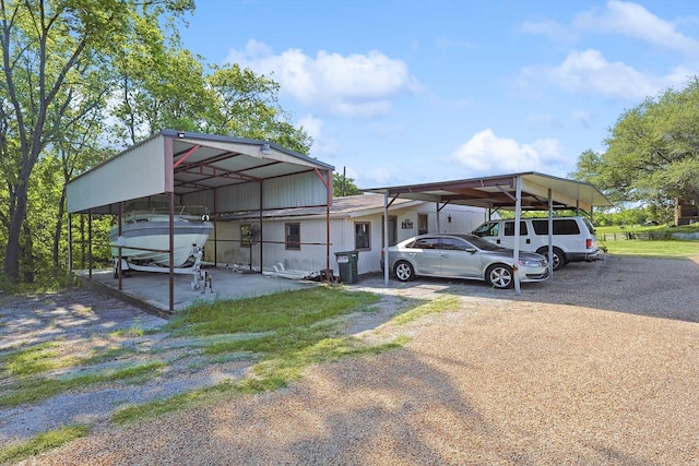 view of parking featuring driveway and a carport