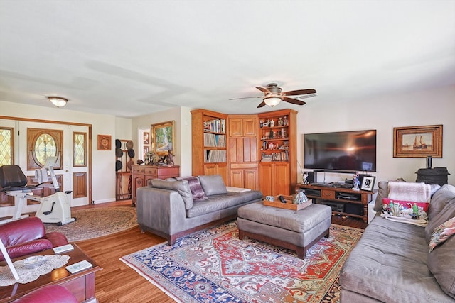 living room with ceiling fan and wood-type flooring