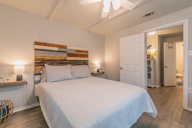 bedroom featuring beam ceiling, dark hardwood / wood-style floors, and ceiling fan