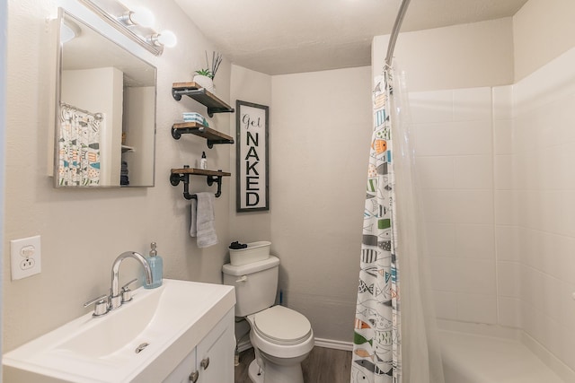 bathroom with a shower with curtain, hardwood / wood-style floors, vanity, and toilet