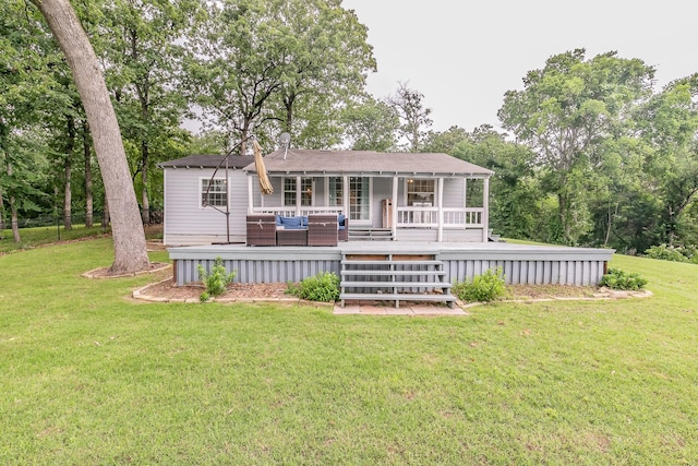 rear view of house featuring an outdoor living space, a yard, and a wooden deck