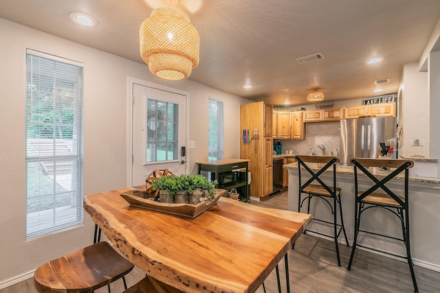 dining room featuring sink and hardwood / wood-style flooring