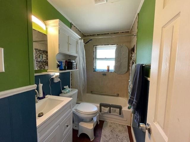 full bathroom with shower / bath combination with curtain, toilet, and vanity