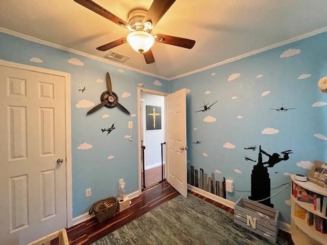 interior space featuring dark hardwood / wood-style floors, ceiling fan, and ornamental molding