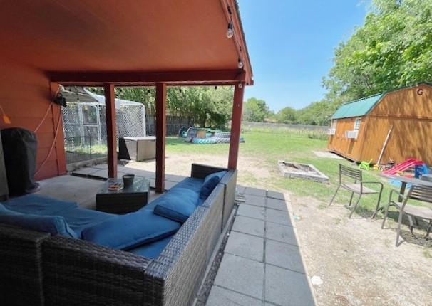 view of patio featuring a storage shed and an outdoor hangout area