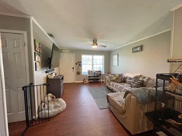 living room featuring dark hardwood / wood-style floors, ceiling fan, and crown molding