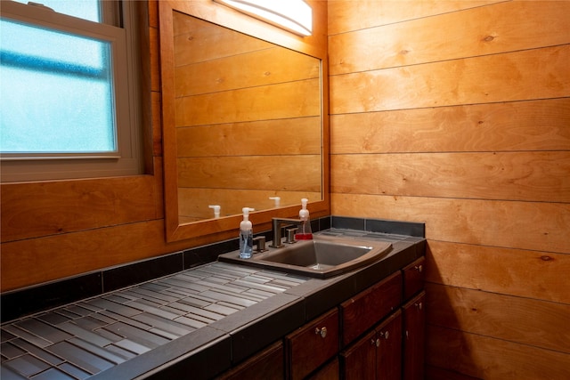 bathroom with wooden walls and vanity