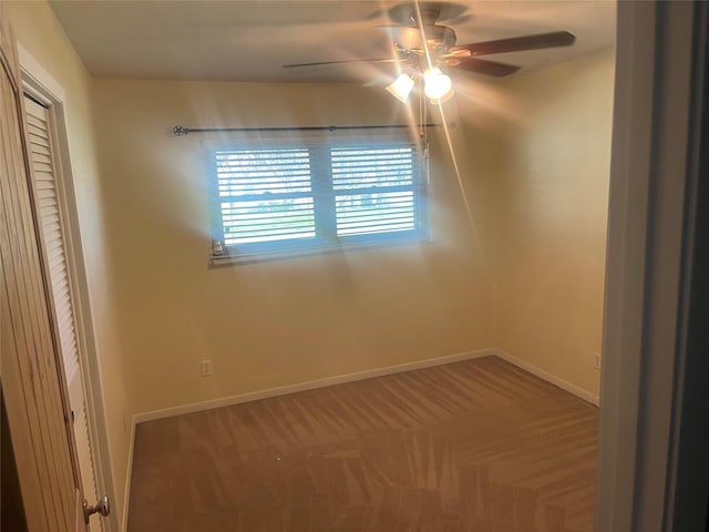 empty room with baseboards, carpet, and ceiling fan