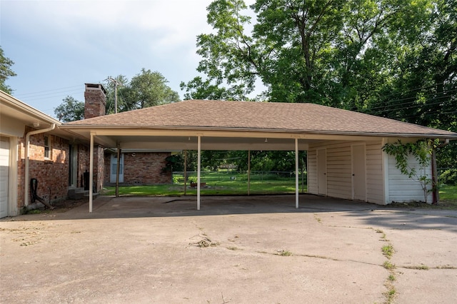 view of parking / parking lot with a carport and concrete driveway