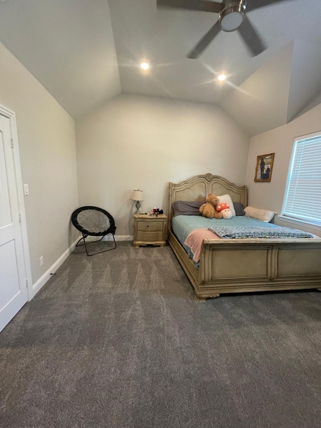 unfurnished bedroom featuring ceiling fan, dark carpet, and lofted ceiling