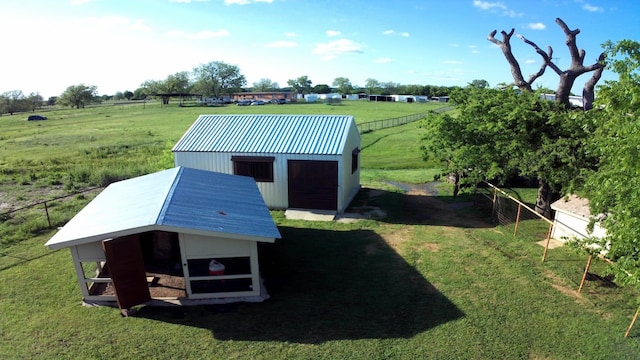 exterior space featuring a rural view and a yard