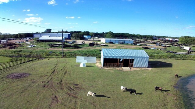 birds eye view of property with a rural view