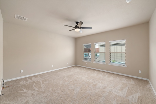 unfurnished room with ceiling fan and light colored carpet