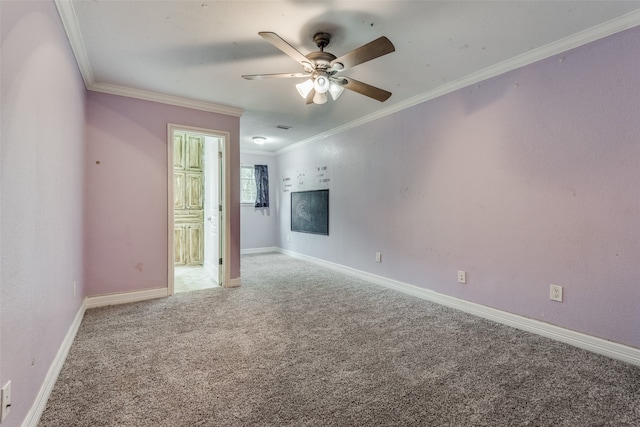 carpeted spare room featuring ornamental molding and ceiling fan