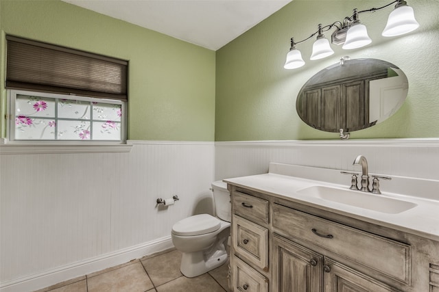 bathroom featuring tile floors, oversized vanity, and toilet