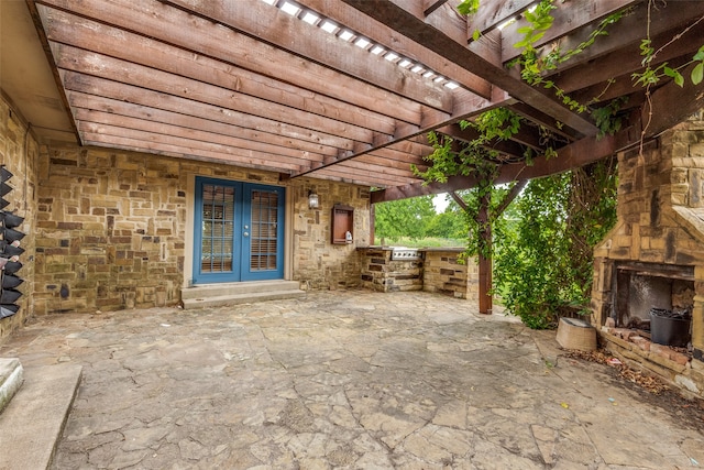 view of patio / terrace with a pergola and an outdoor kitchen