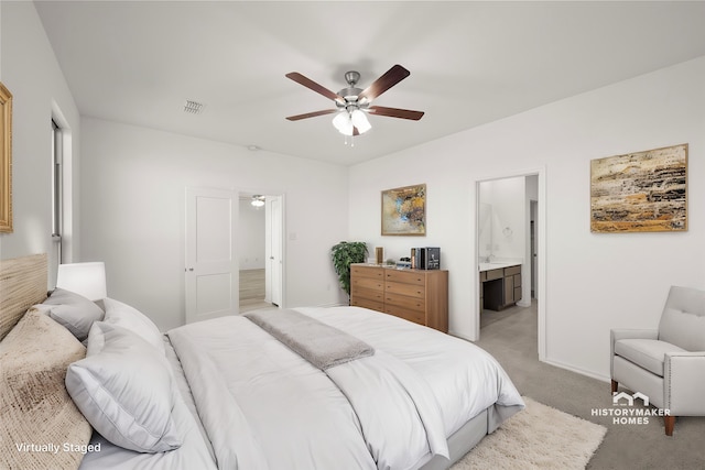 carpeted bedroom featuring ensuite bathroom and ceiling fan