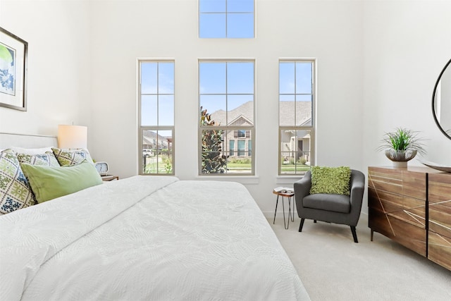 carpeted bedroom featuring multiple windows