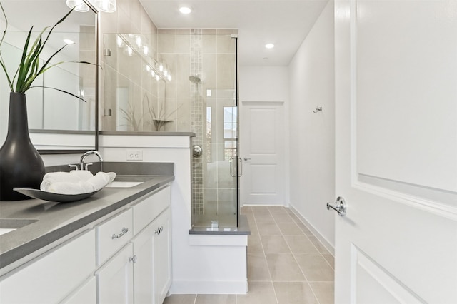 bathroom featuring walk in shower, vanity, and tile patterned floors