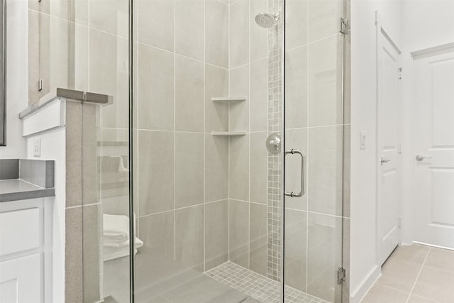 bathroom featuring vanity, an enclosed shower, and tile patterned floors