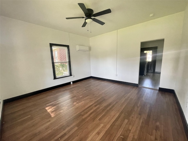 spare room with a wall mounted air conditioner, dark wood-type flooring, ceiling fan, and a healthy amount of sunlight