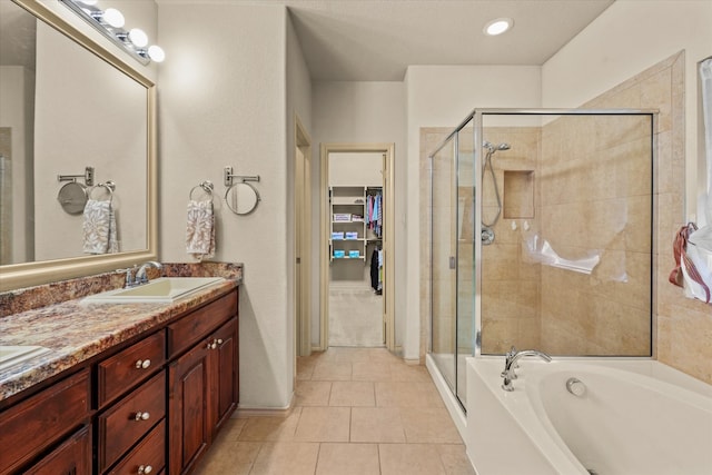 bathroom featuring tile patterned flooring, vanity, and separate shower and tub