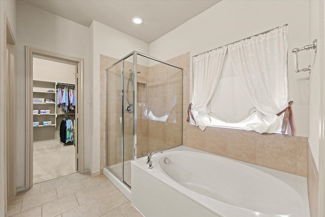 bathroom with tile patterned flooring and separate shower and tub