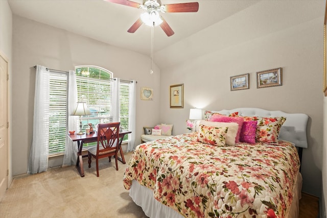 bedroom with light carpet, multiple windows, vaulted ceiling, and ceiling fan