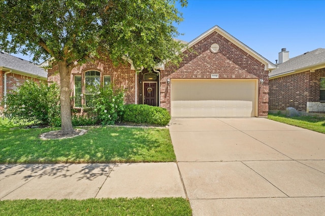 view of front facade with a front yard and a garage