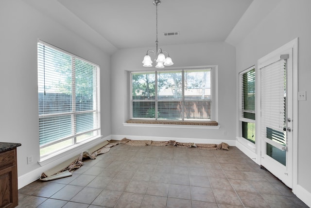 unfurnished dining area with a chandelier and light tile patterned flooring