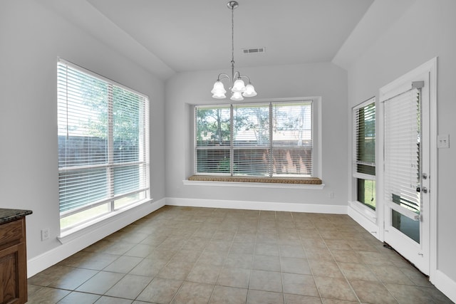 unfurnished dining area featuring light tile patterned floors, a chandelier, and vaulted ceiling