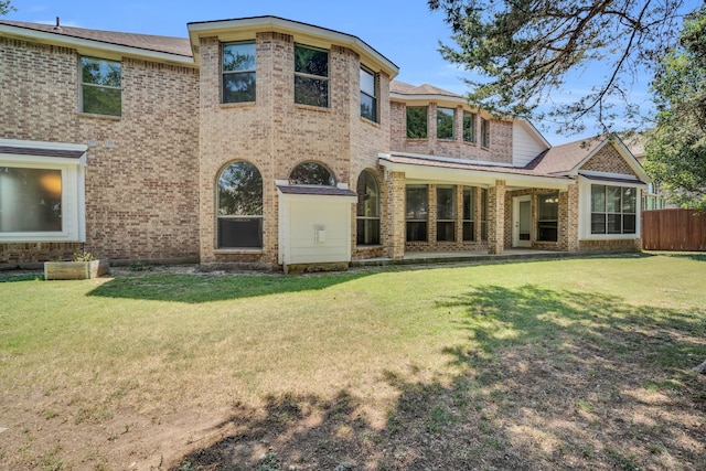 back of house with a lawn