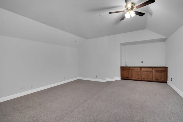 additional living space featuring light carpet, vaulted ceiling, and ceiling fan