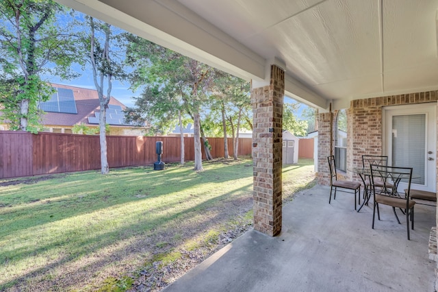 view of yard with a shed and a patio