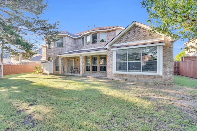 back of house featuring a yard and a patio