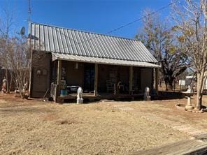 rear view of house featuring a porch