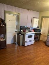 kitchen with white electric range oven and hardwood / wood-style flooring