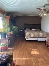 bedroom featuring ceiling fan and hardwood / wood-style floors