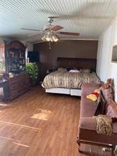 bedroom featuring ceiling fan and wood-type flooring