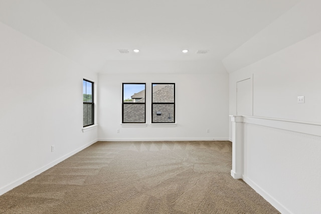 empty room with carpet and lofted ceiling