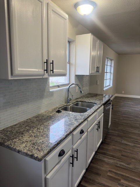 kitchen featuring white cabinets, tasteful backsplash, and dark wood-type flooring