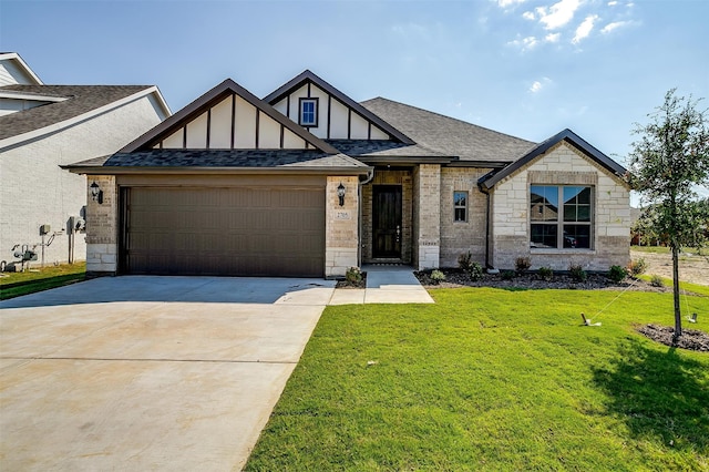 view of front of house featuring a garage and a front lawn