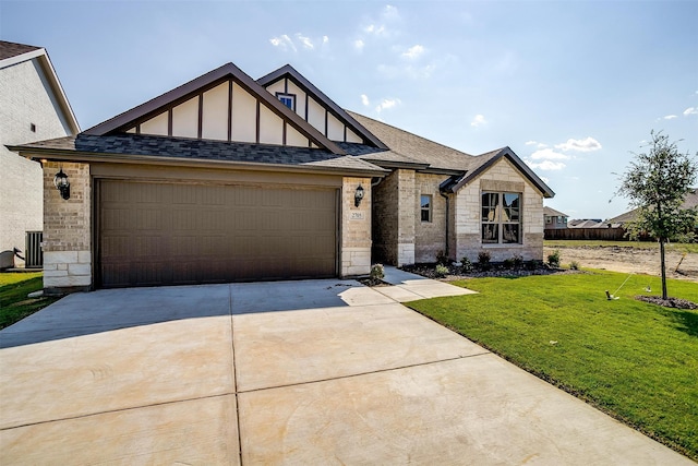 view of front facade with central AC unit, a front yard, and a garage