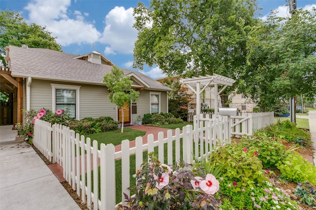 view of front facade with a front lawn and a pergola